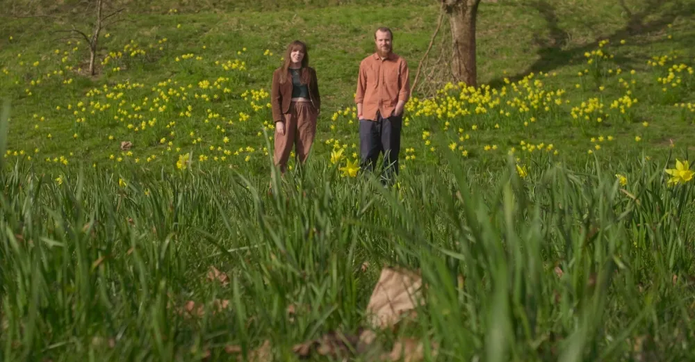 An image of two people in the countryside.